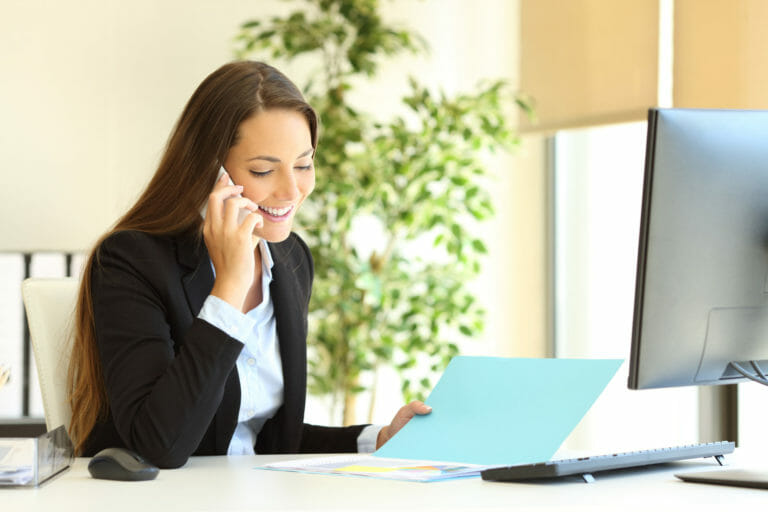 office worker checking document talking on phone